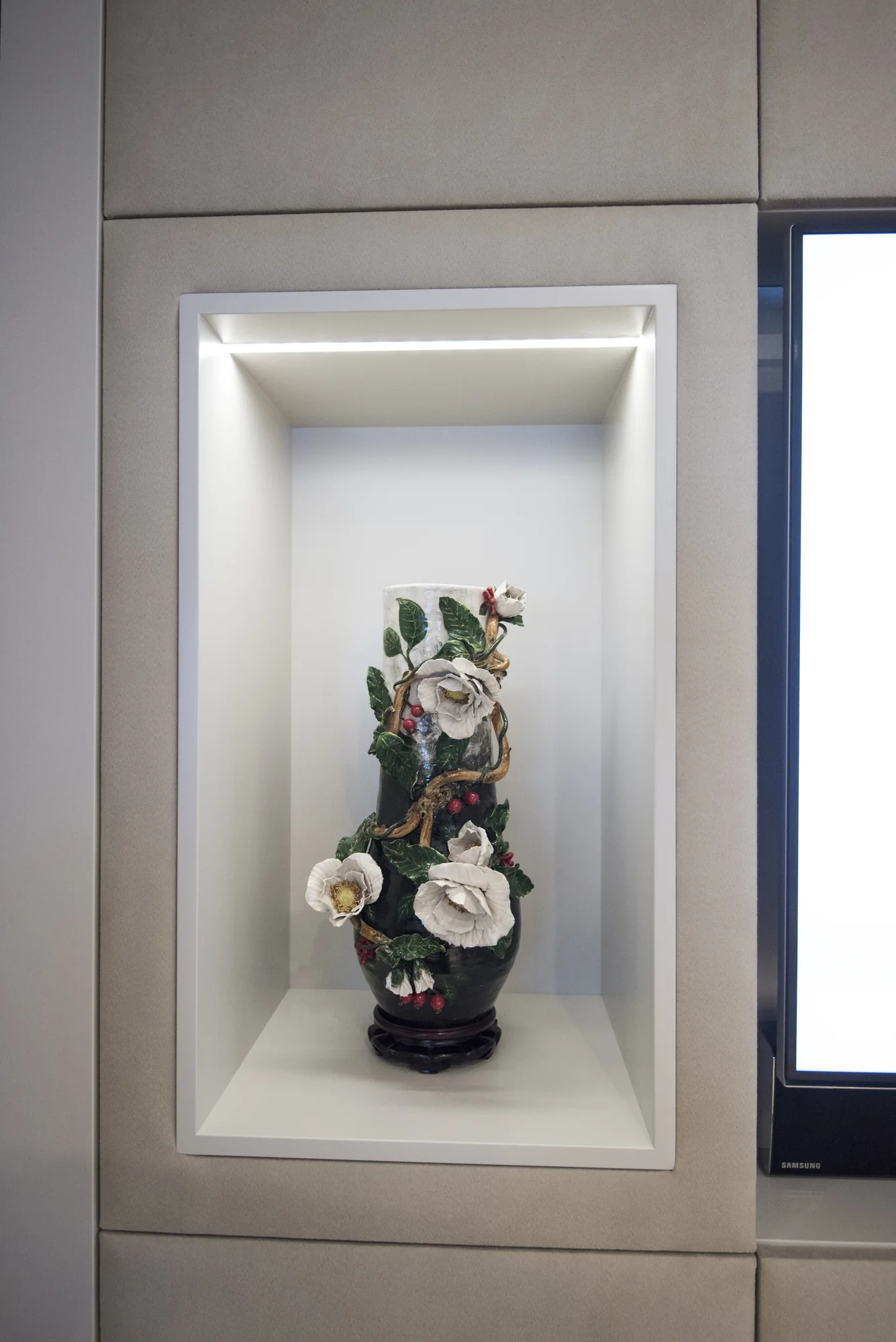 Illuminated display-niche detail in cream media unit