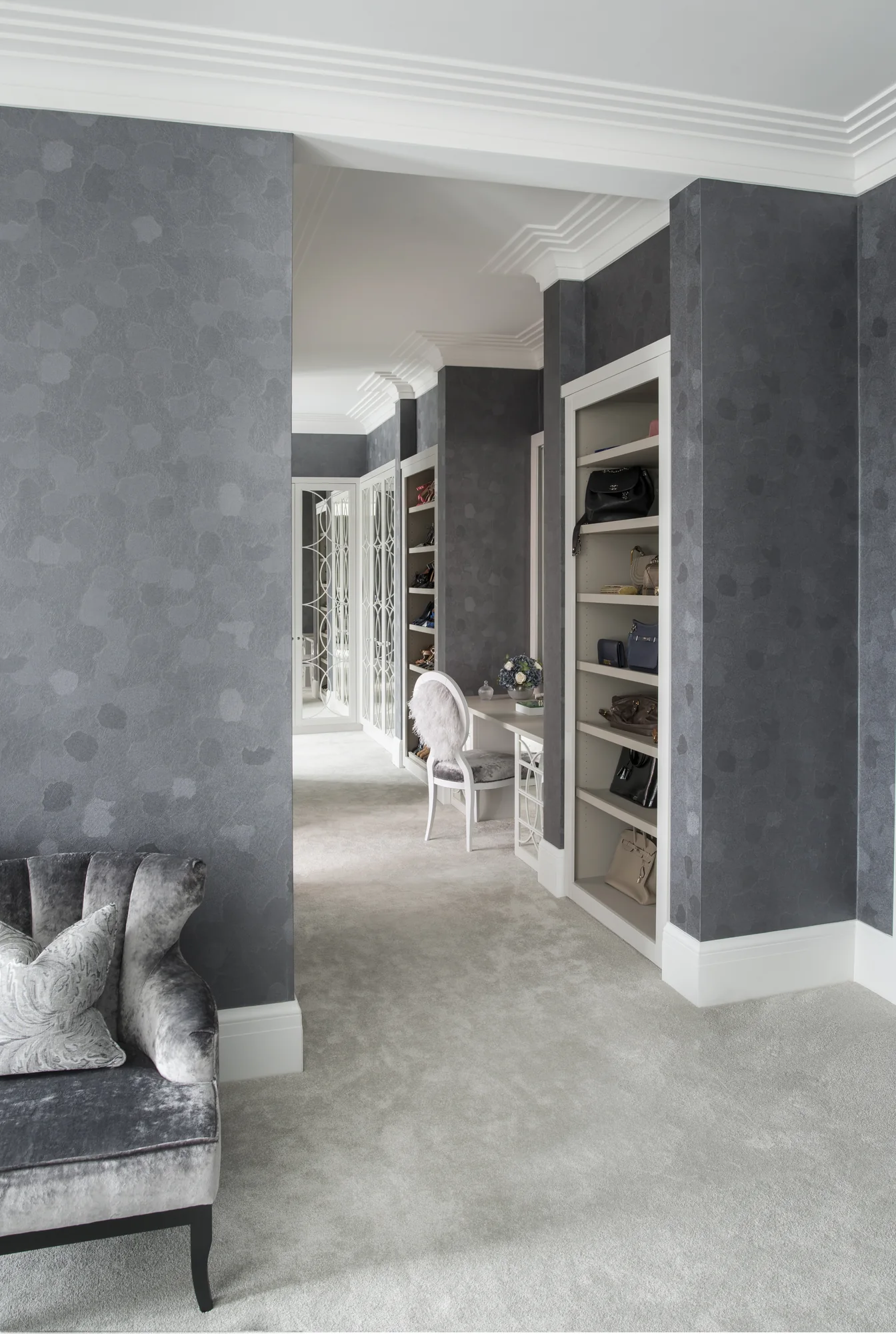 Dressing-room view showing mirrored wardrobes and open shoe shelves