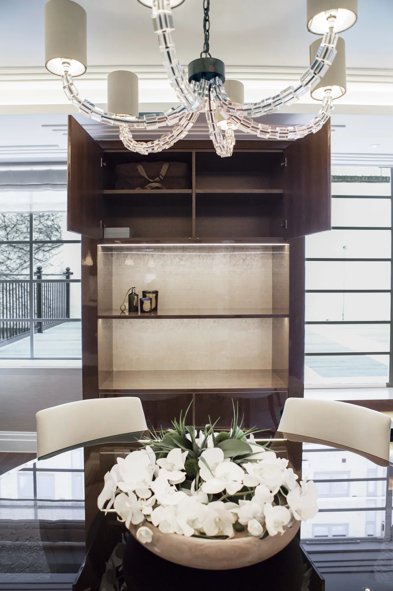 Front view of illuminated dining display shelves above the table