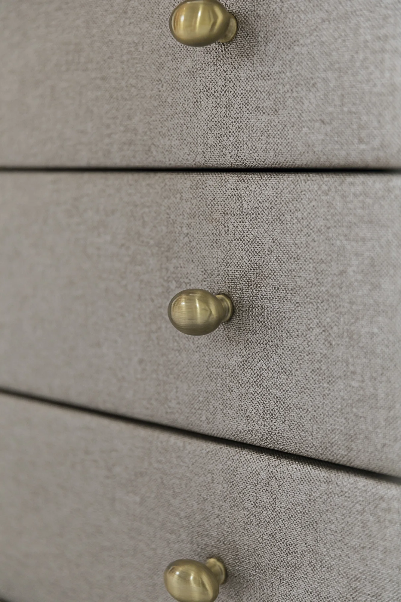 Textured drawer fronts with small rounded metallic handles