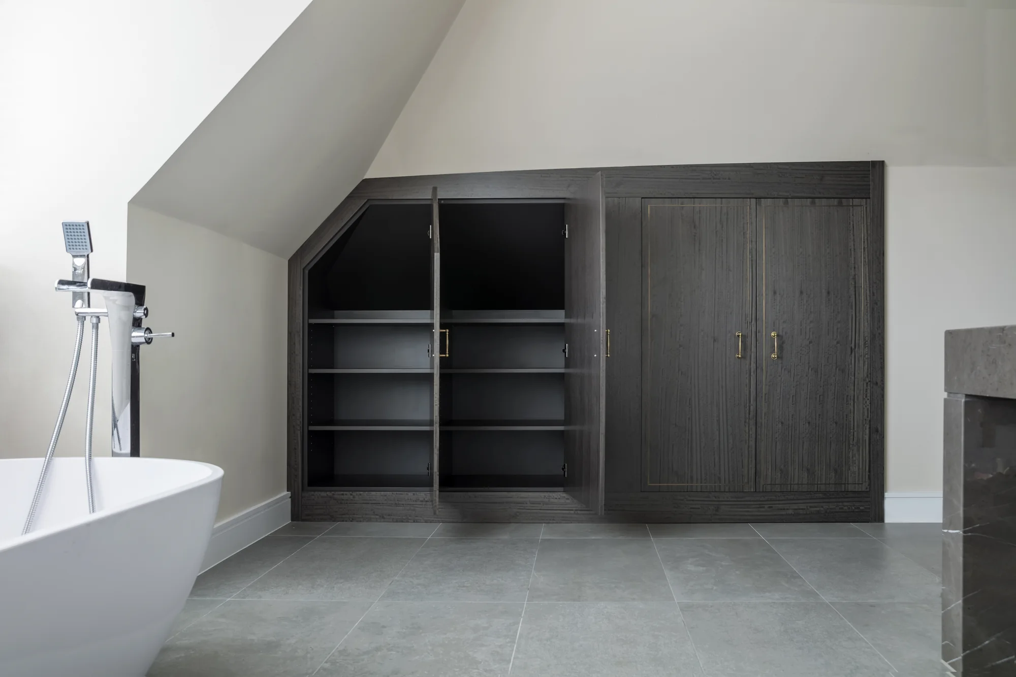 Open bathroom cupboard doors revealing internal shelving