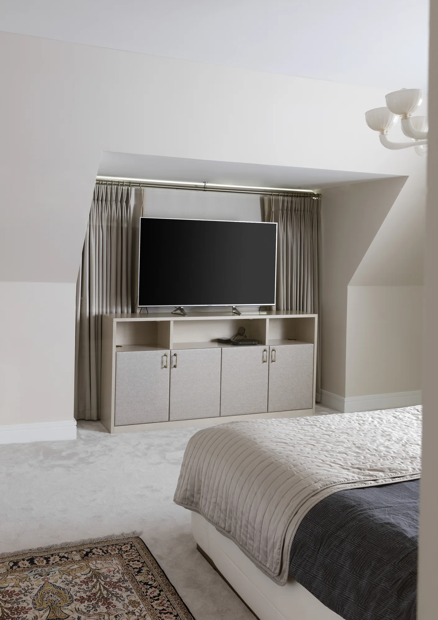 Room view of the fitted bedroom television cabinet and reflective surround