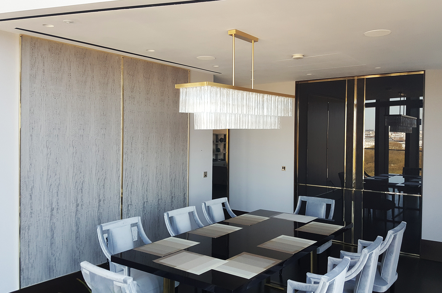 Dining room view of panelled doors with polished brass lines