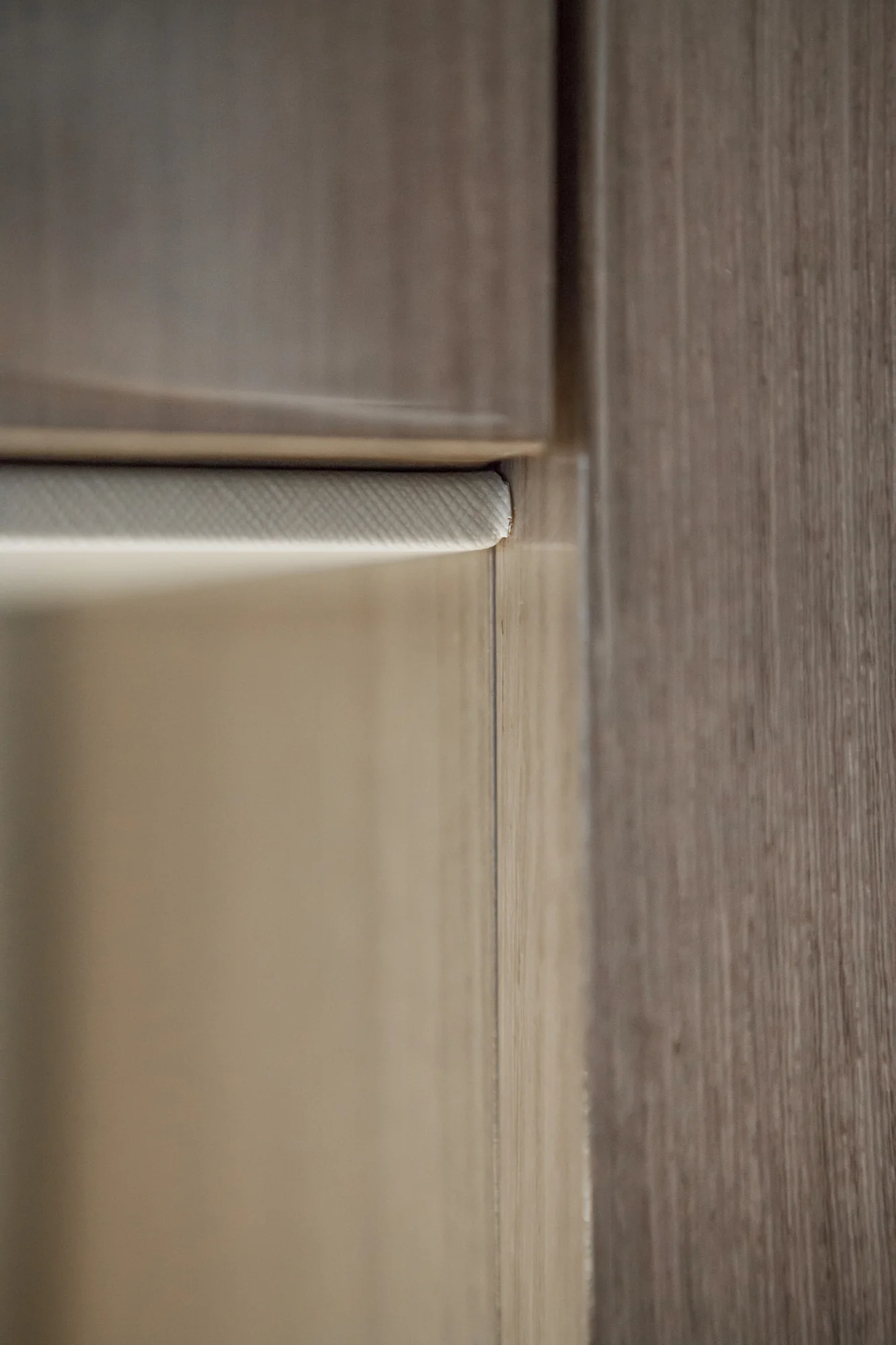 Detail of the pale horizontal band across a glossy wardrobe door