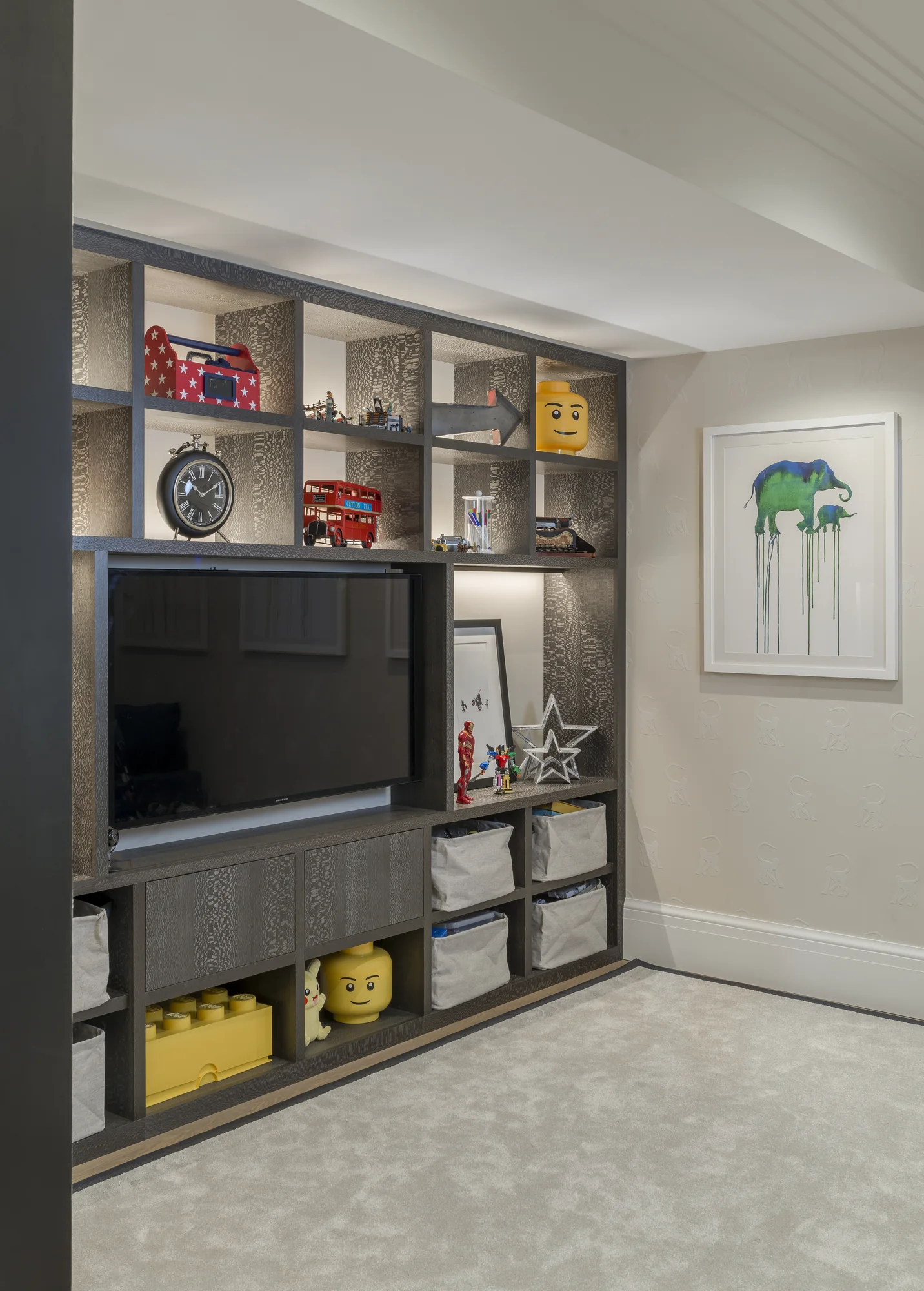 Angled view of the fitted playroom TV cabinet and low toy compartments