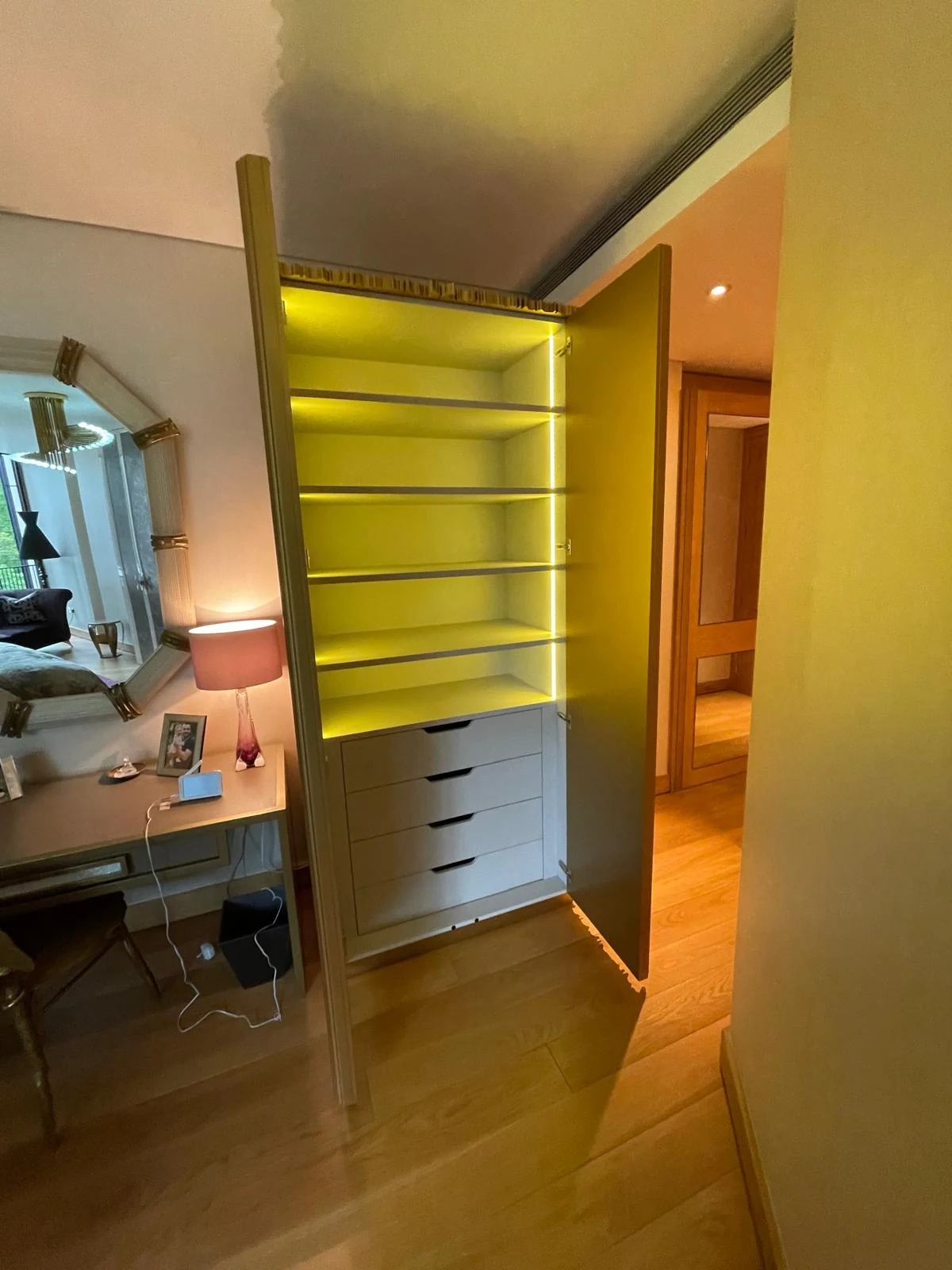 Three-quarter view of the open sculptural cabinet.