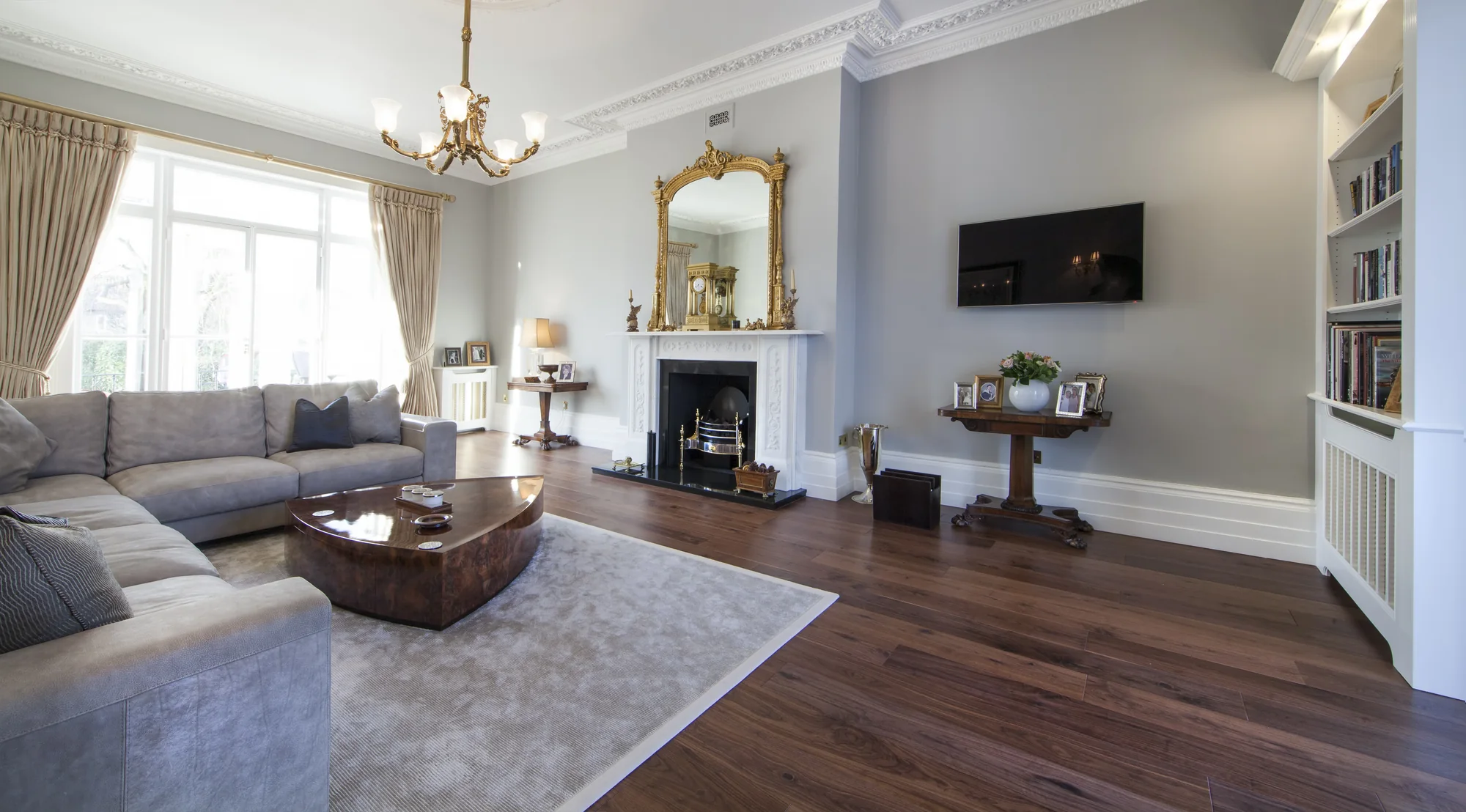 Wider living-room view showing shelving, fireplace and fitted room details