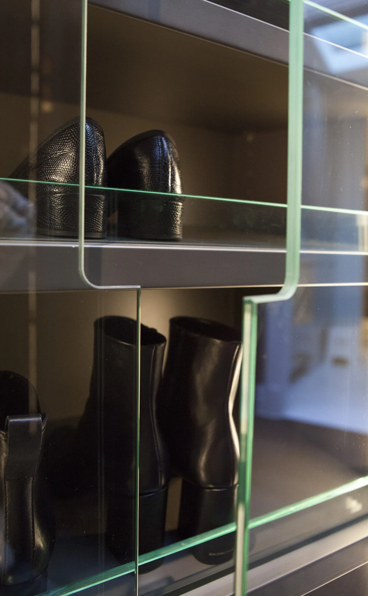 Glass wardrobe doors with shaped finger openings and illuminated accessory shelves
