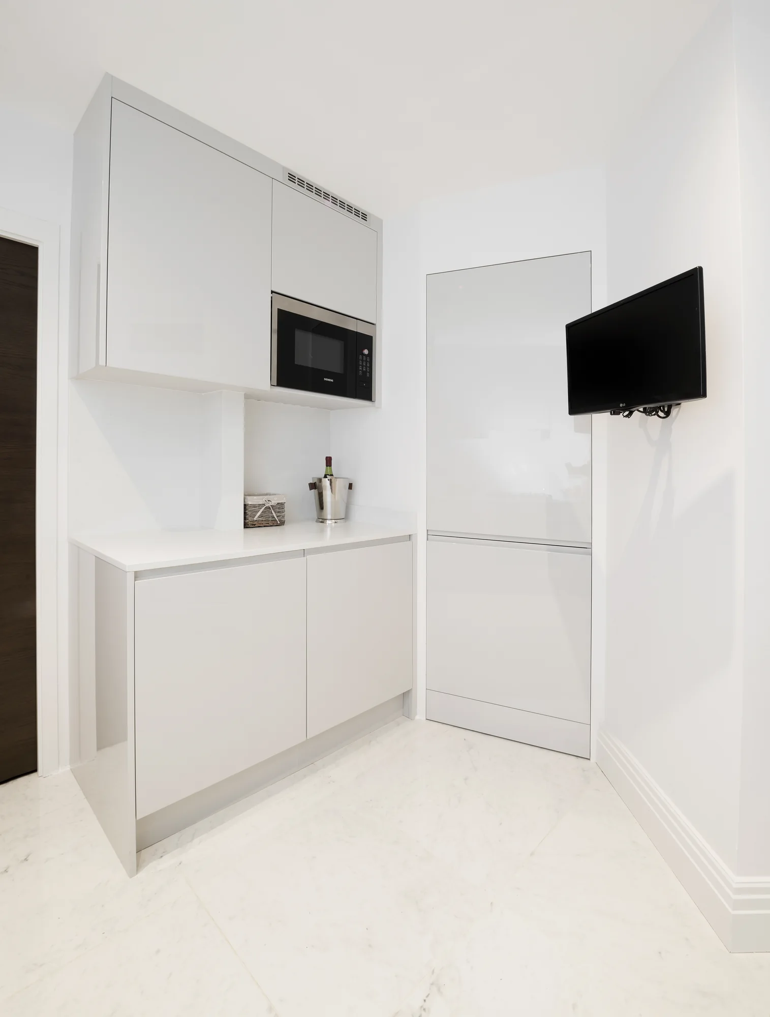 Closed utility cabinetry beside the kitchen