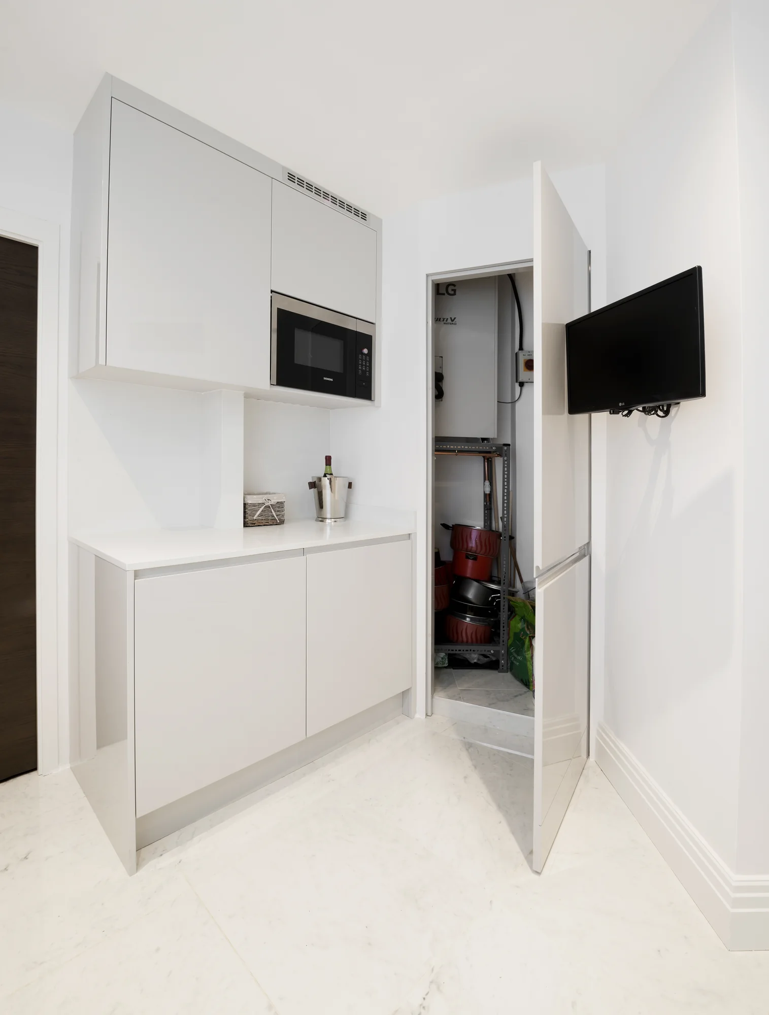Open tall cupboard in the kitchen utility area