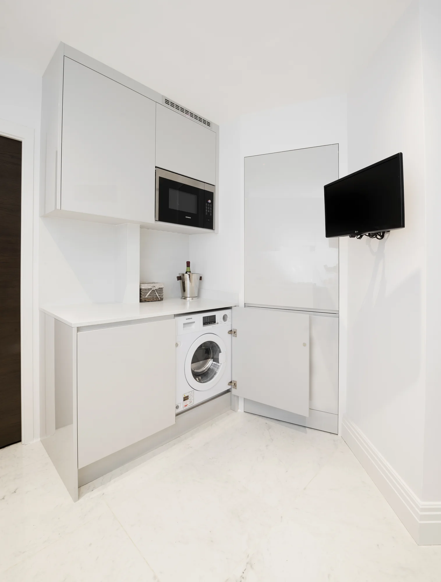 Washing machine concealed behind a matching cabinet door
